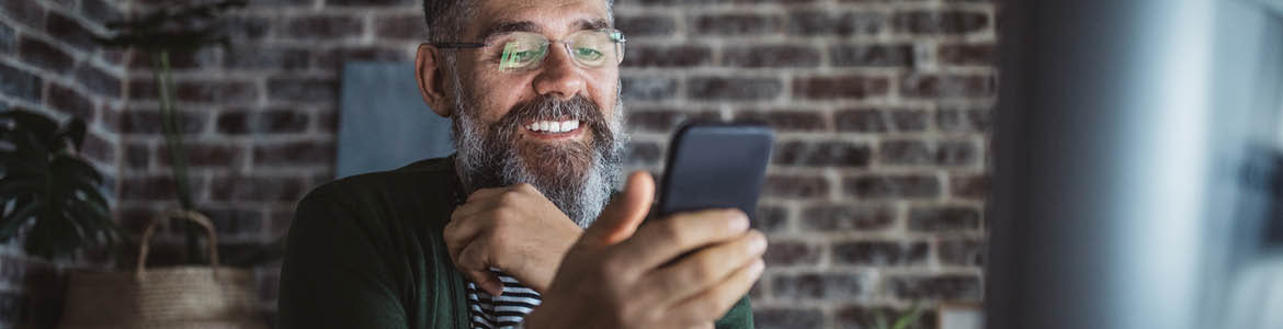 Bearded man viewing mobile phone